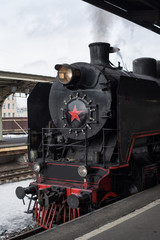 Fototapeta na wymiar vintage steam train at the station. Steam from steam pipe.