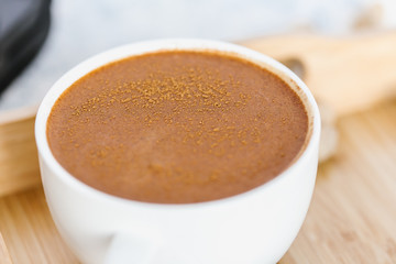 Coffee, sprinkled with cinnamon, soft focus