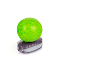 Sweet candies of different color lie on a white background