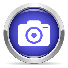 Camera icon. Round bright blue button.