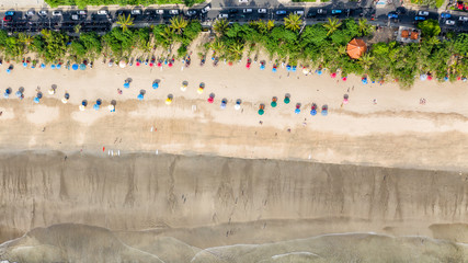 Top aerial view of color umbrellas on the Kuta beach,  Bali
