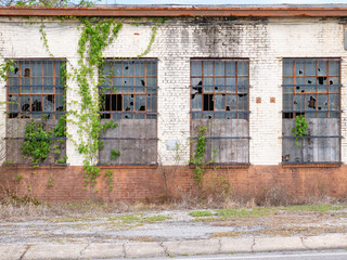 old abandoned block industrial building with broken windows