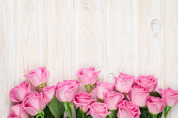 Pink roses over wooden table