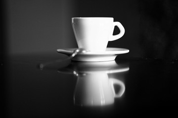  isolated white coffee cup with plate and spoon with reflection and red background