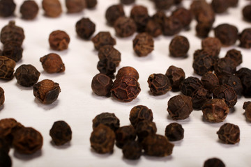 Black pepper spice balls isolated over the white background