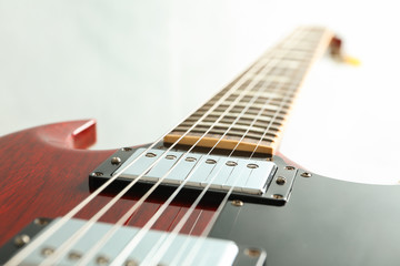 Beautiful six - string electric guitar on white background, closeup