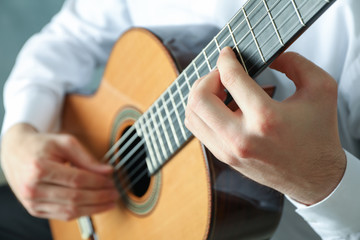 Man playing on classic guitar, space for text