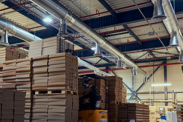 Warehouse with modern ventilation system full of raw material.