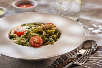 Homemade Tagliatelle pasta with zucchini, tomatoes and cod