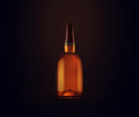 Full whiskey bottle on dark background. Product packaging brand design. Mock up drink with place...