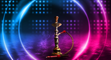 Hookah smoking on a dark abstract background. Background of empty scenes with neon lights and colored lights, reflection of night lights on wet asphalt