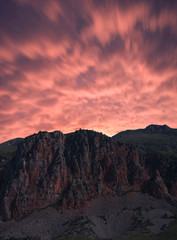 Fototapeta na wymiar Beautiful red rocks,dramatic clouds at the night . Armenia Noravank.