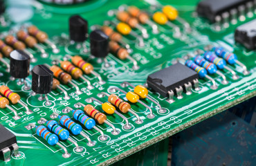 Electronic components. Integrated circuits, resistors, transistors and capacitors on PCB. Green...