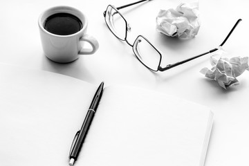 work desk of writer with notebook, glasses, coffee on white background mock up