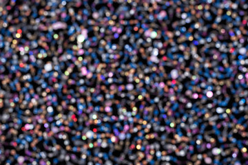 Texture of black cloth with colorful sequins. Close-up.