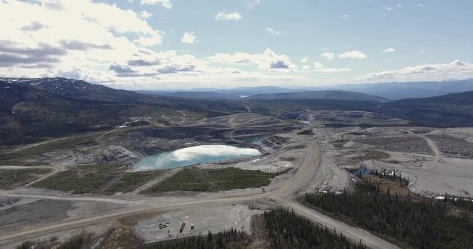 Aerial 4k - High Altitude shot of the Grum Pit at the Abandoned Faro Mine