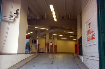 garage entrance and exit with owls and ceiling light concrete floor