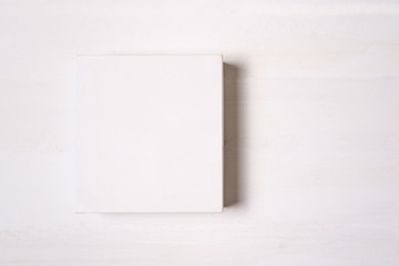 White paper square gift box isolate on light background. Flat lay