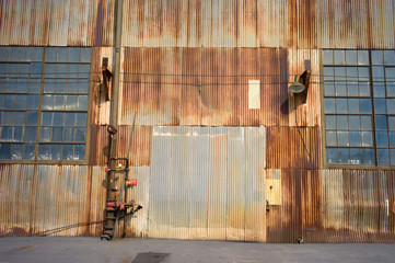 old  rusty warehouse door and windows in old abandoned industrial building on pier 70 in San...