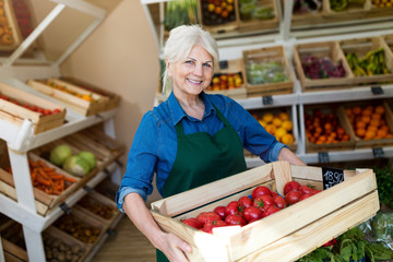 Senior woman working in small grocery store