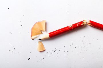 Broken red pencil on white