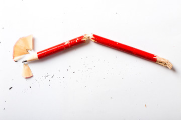Broken red pencil on white