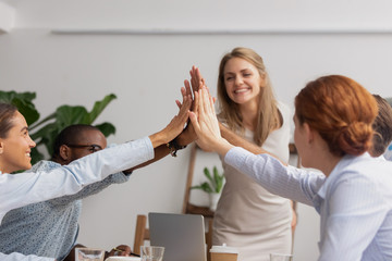 Reliable happy diverse business team people give high five together
