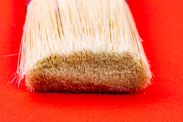 white bristles paintbrush on red background
