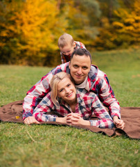 Family on weekend. Mother father and son in park