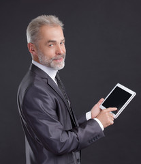 modern businessman using digital tablet.isolated on black background
