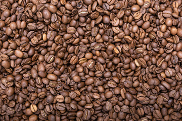 Roasted brown coffee beans pattern. Coffee background. Top view. Flat texture.