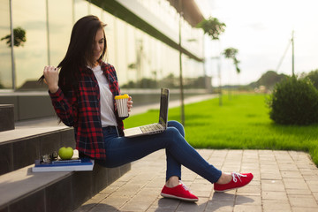 Young brunette woman student working outdoors