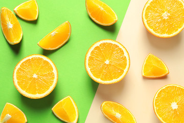 Flat lay composition with ripe oranges on color background