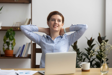 Happy calm business woman employee take break at work desk