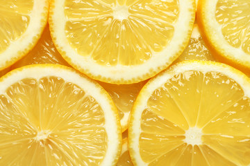 Juicy lemon slices as background, top view. Citrus fruit