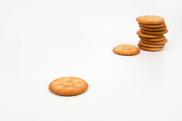 Stack of salted biscuits isolated on white background.