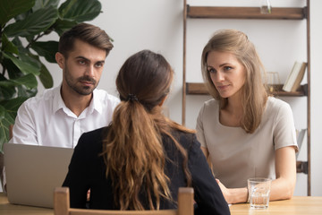 Serious doubtful hr managers listening to applicant at job interview