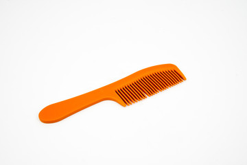 Orange color comb isolated on white background