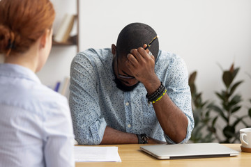 Upset african applicant depressed about rejection on failed job interview