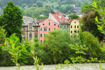 Fototapeta na wymiar colorfull houses, church tower, bridge, along river Inn, Innsbruck, Austria