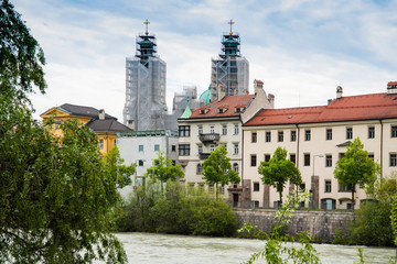 Fototapeta na wymiar colorfull houses, church tower, bridge, along river Inn, Innsbruck, Austria