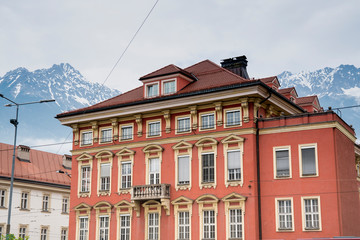 Fototapeta premium orange building in Innsbruck with mountains, Tyrol, Austria