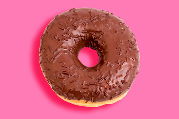 chocolate donut on a pink background. Creative trend food concept