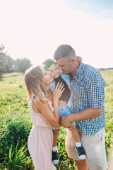 Happy family in park in sunny summer day