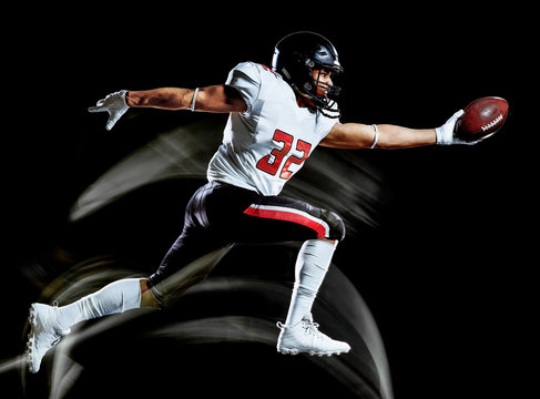 one african american football player man studio shot isolated on black background with light painting with blurred motion speed effect