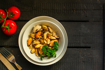 mussels A serving of seafood is a white plate. food background. top image