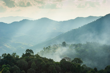 Sunset light shines on the mountains and tribe village.