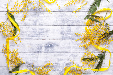Mimosa flowers on a wooden table Frame