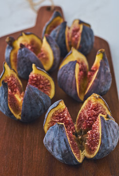Quartet figs on a wooden board