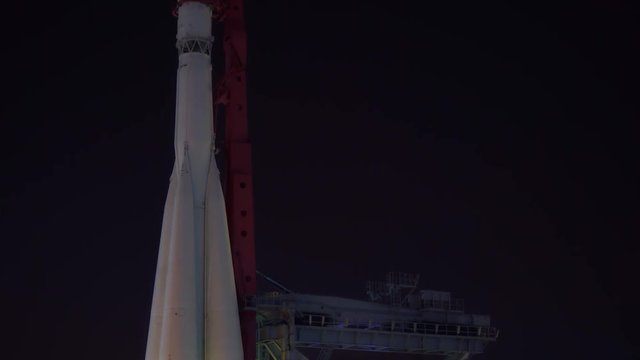 A rocket ready to fly into space on the launch pad. Night. The frame moves from the bottom up and back down. Full-size museum copy of the rocket of the Soviet Union. Spaceship. Ultra HD stock footage